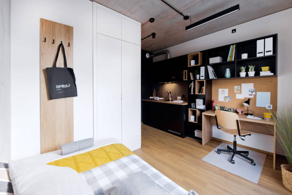A self-contained Shed Kraków room designed for studying and everyday living.