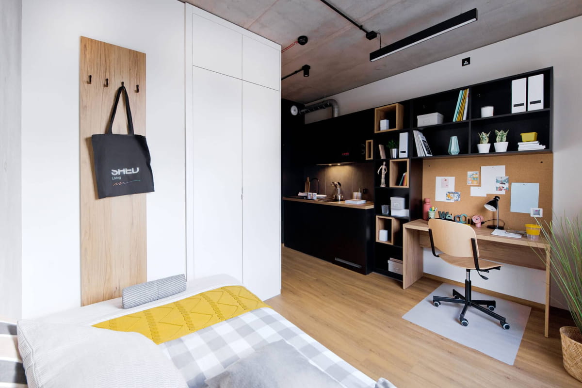 A self-contained Shed Kraków room designed for studying and everyday living.