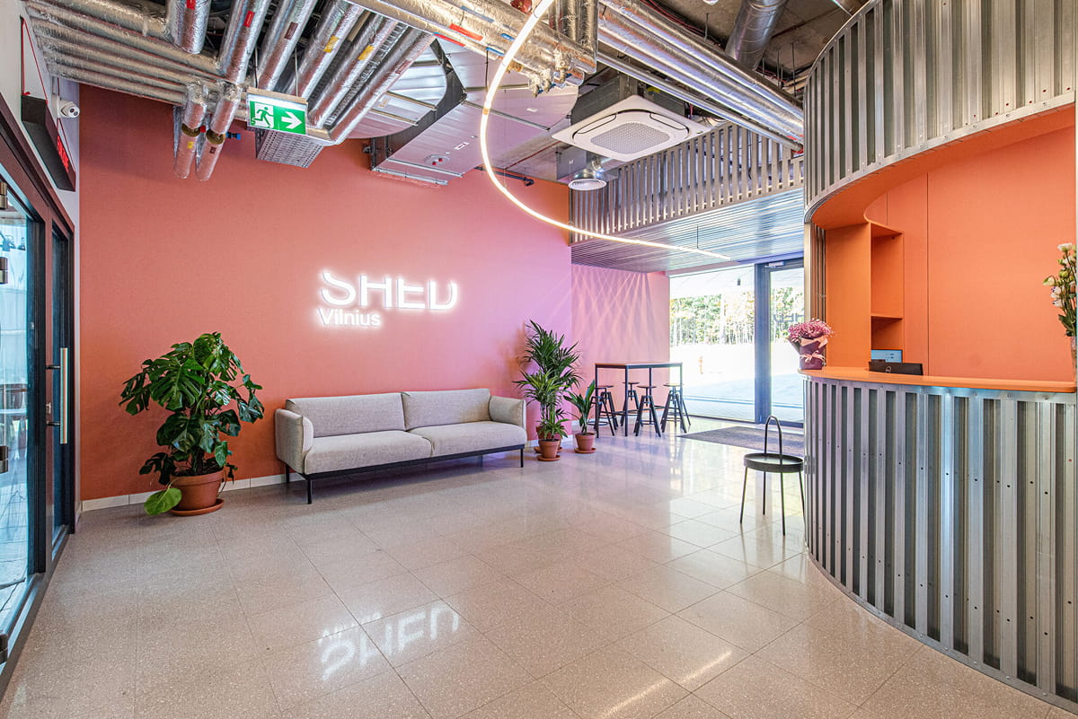 Shed Vilnius combines private rooms with reception and shared social facilities.